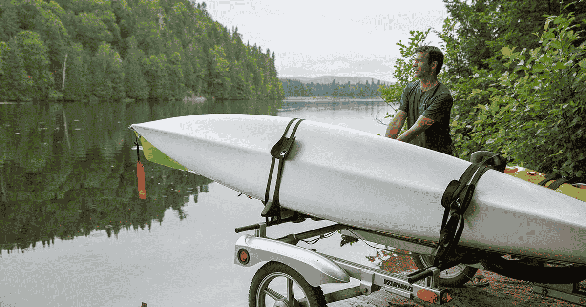 transporting your kayak and what to consider when storing it ken whiting using a kayak in front of the water