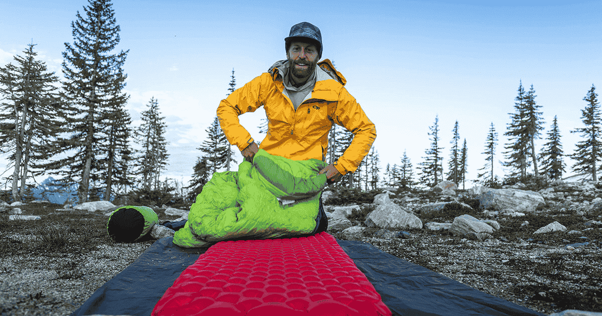 eric hanson laying out his sleep system for backpacking and hiking in revelstoke british columbia backpacking for beginners