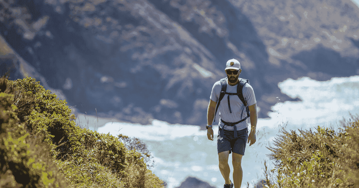 eric with the pacific ocean behind him while hiking and backpacking