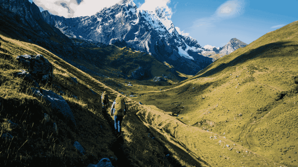 how to go on an international trek two backpackers climbing a high mountain in peru