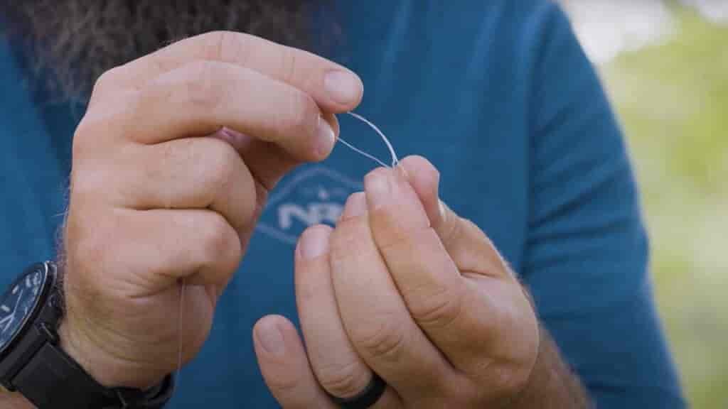 Step 6 - Pass the tag end back through the overhand knot