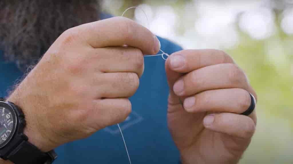 Step 4 - Pull everything down close to the eye of the jighead until the overhand knot is relatively small