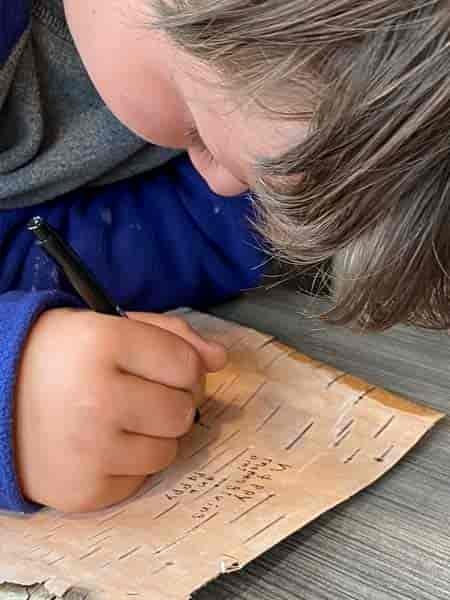 Tucker, the history buff, writing his homework out on birch bark!  Whatever works!!!