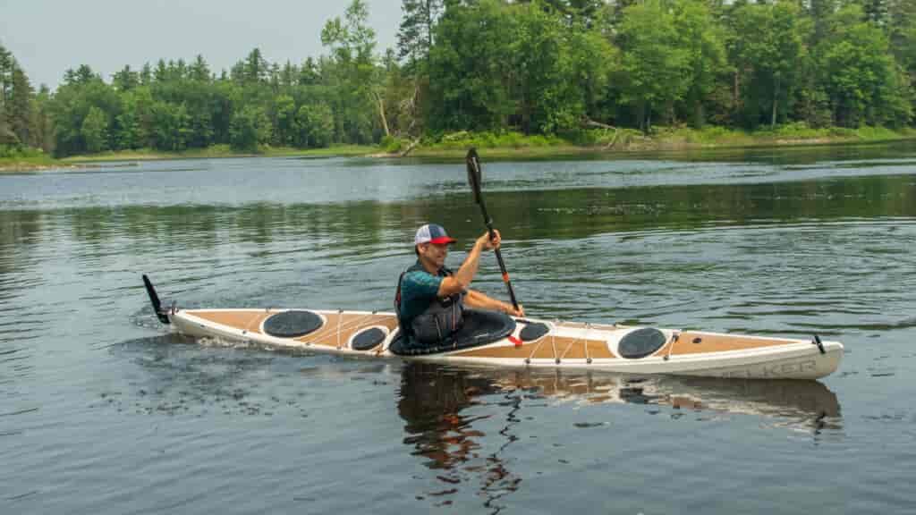 This boat has a drop down skeg to keep it straight.  With the skeg up, it turns well.