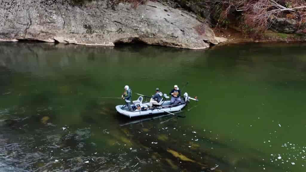 drone shot of three men in flycraft guide 3 person inflatable boat