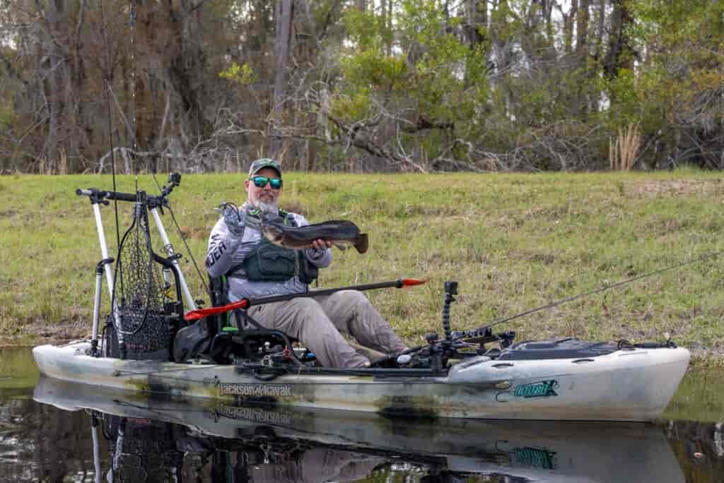 Kayak Fishing Okefenokee  swap fishing with Chris funk sitting in boat holding caught fish